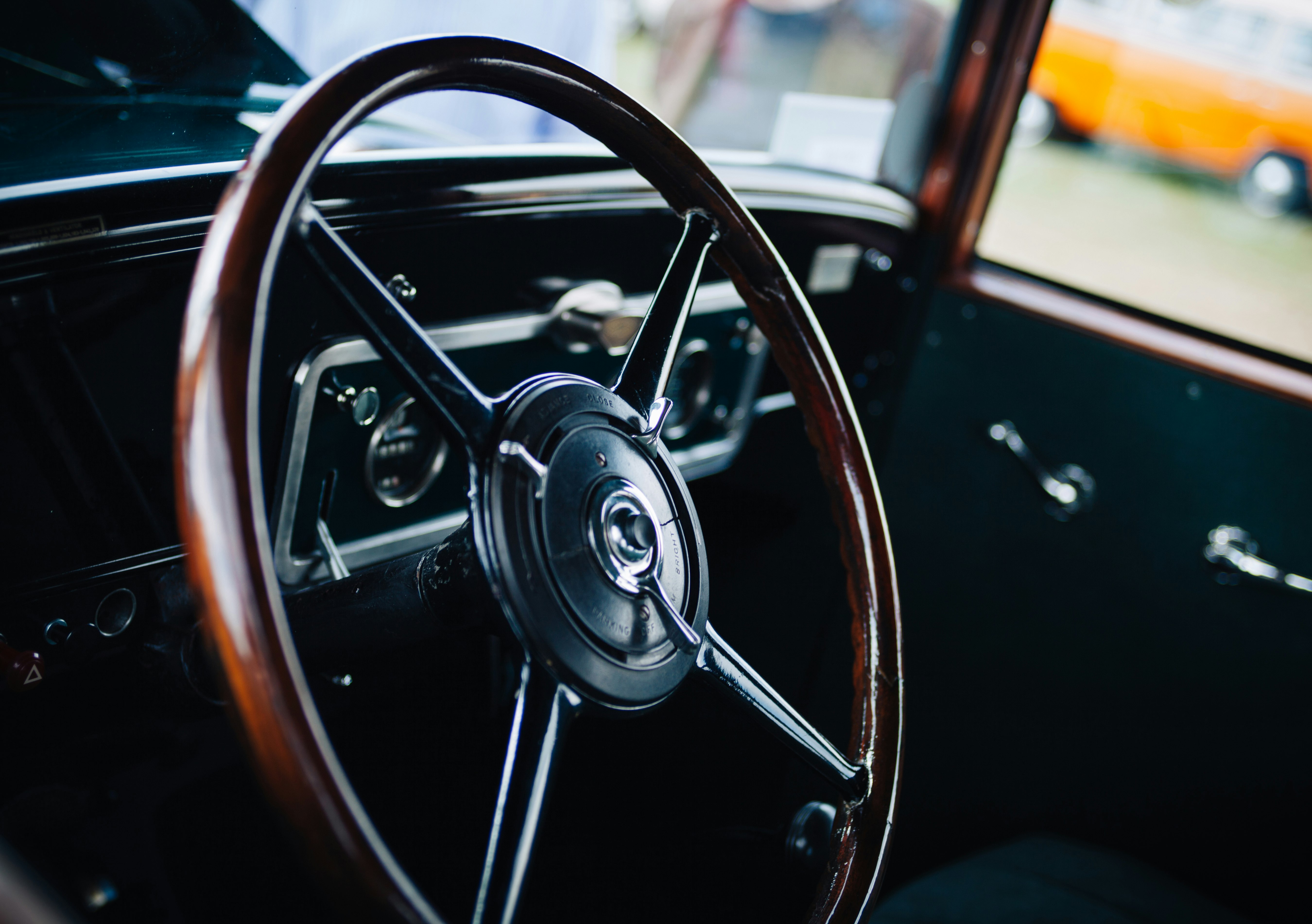 closed up photo of brown and black vehicle steering wheel